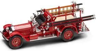 A vintage red fire truck with ladders and hoses on the side.