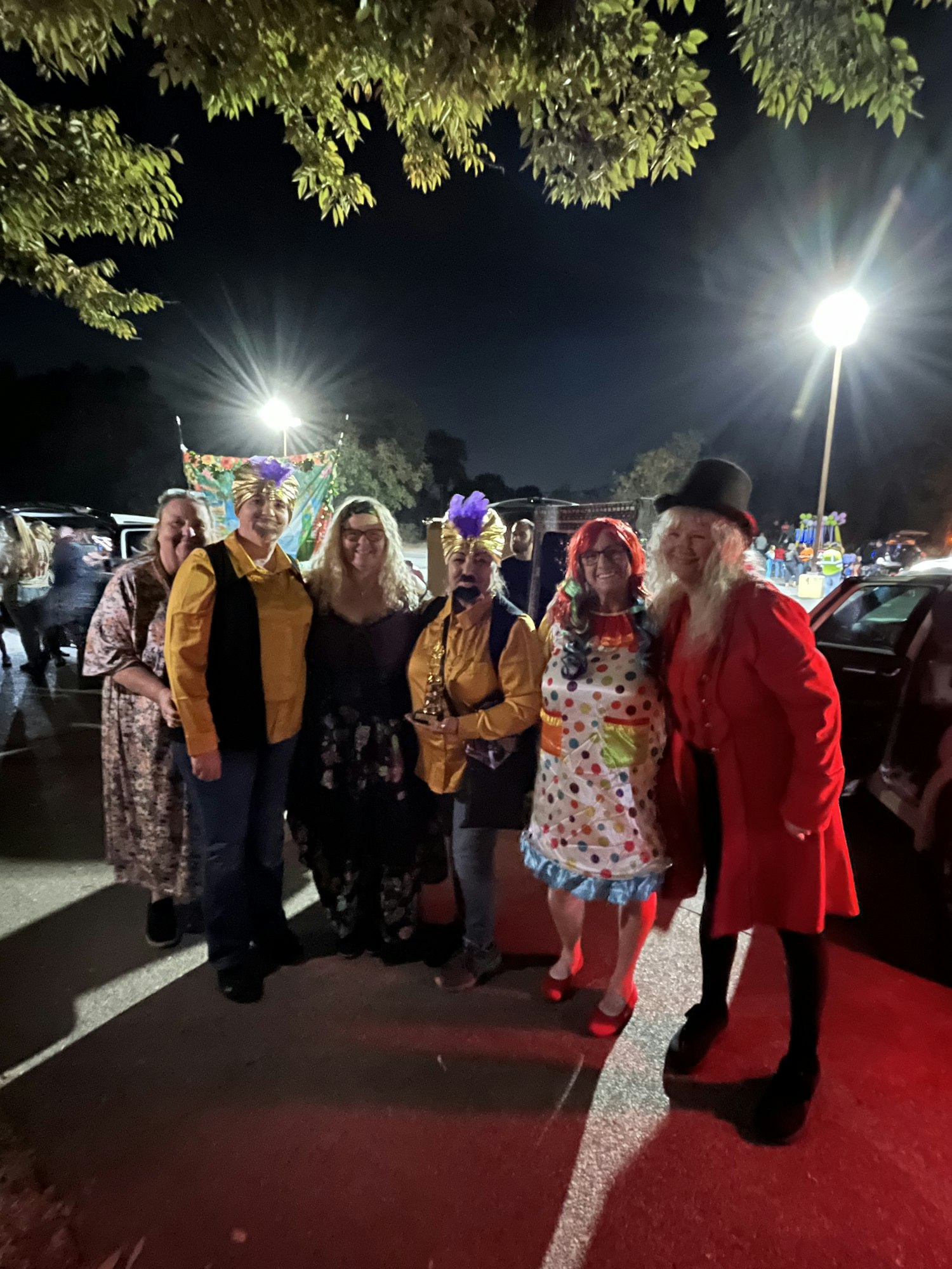 People wearing costumes at night, possibly at a festive gathering. The image is rotated 90 degrees.