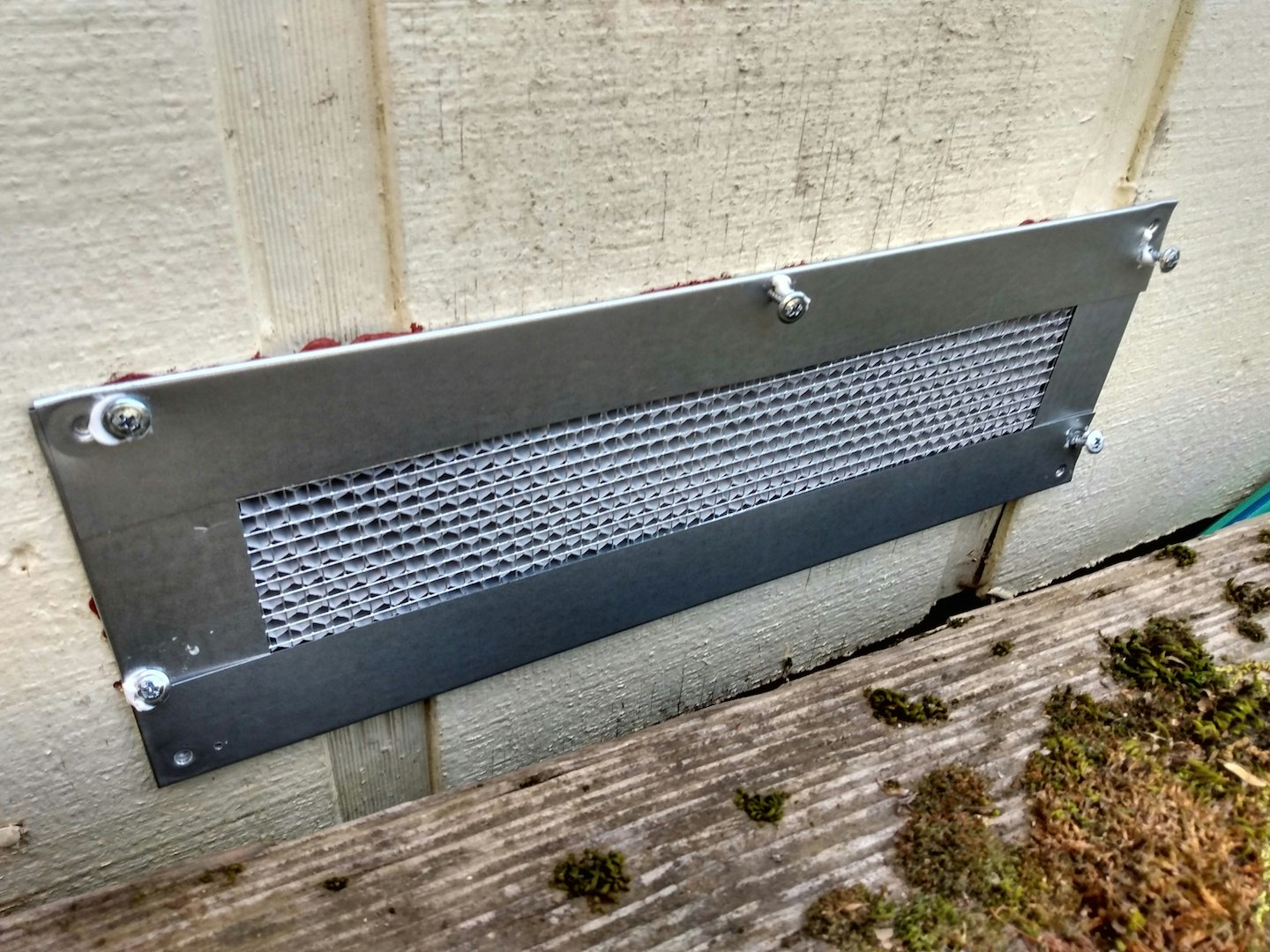 Newly installed foundation vent with caulking