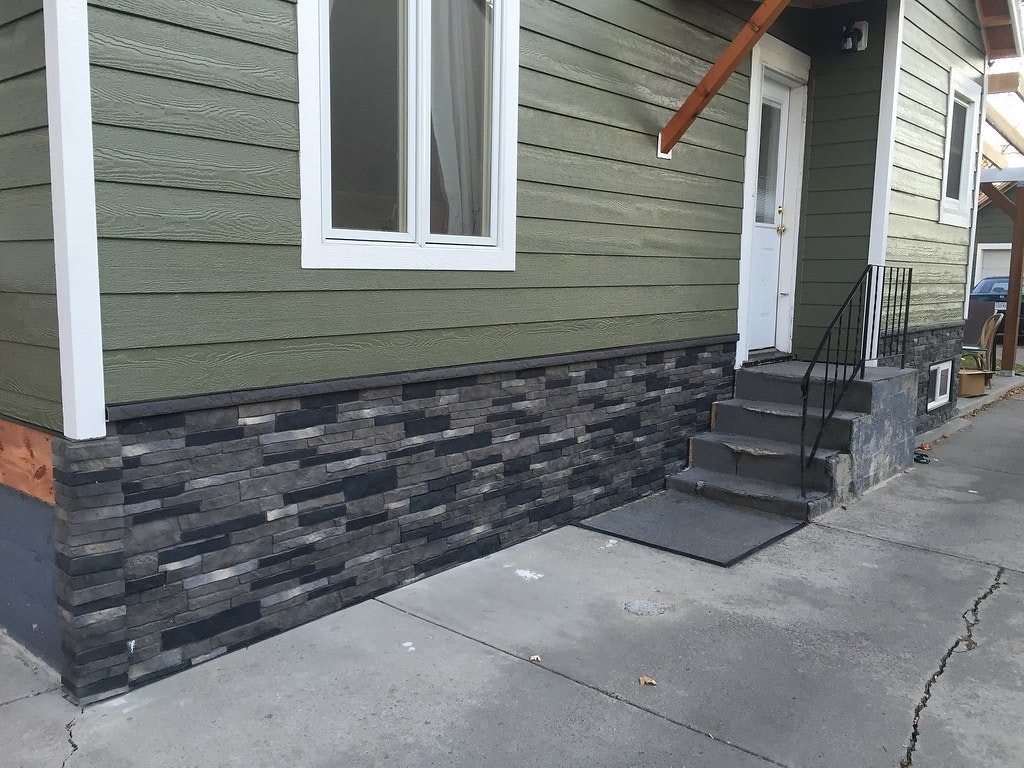 Stone siding at base of wall