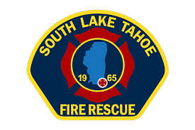 The badge of South Lake Tahoe Fire Rescue, featuring a lake silhouette, a medical symbol, and founding year 1965.