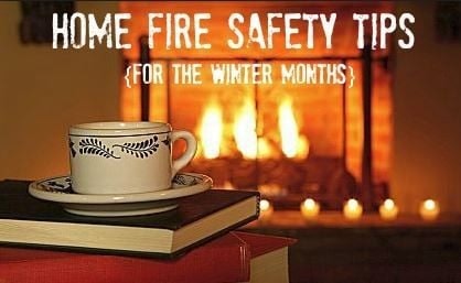 Cup on books by a fireplace with text: "Home Fire Safety Tips for the Winter Months."