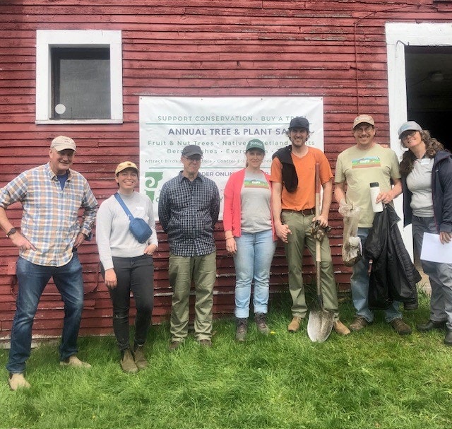 a group of district staff and board members working at the plant sale