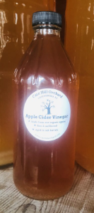 A bottle labeled "Apple Cider Vinegar" from Cox Hill Orchard.
