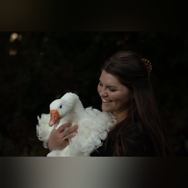District staff member, Rebekkah, holding one of her beloved geese in her arms