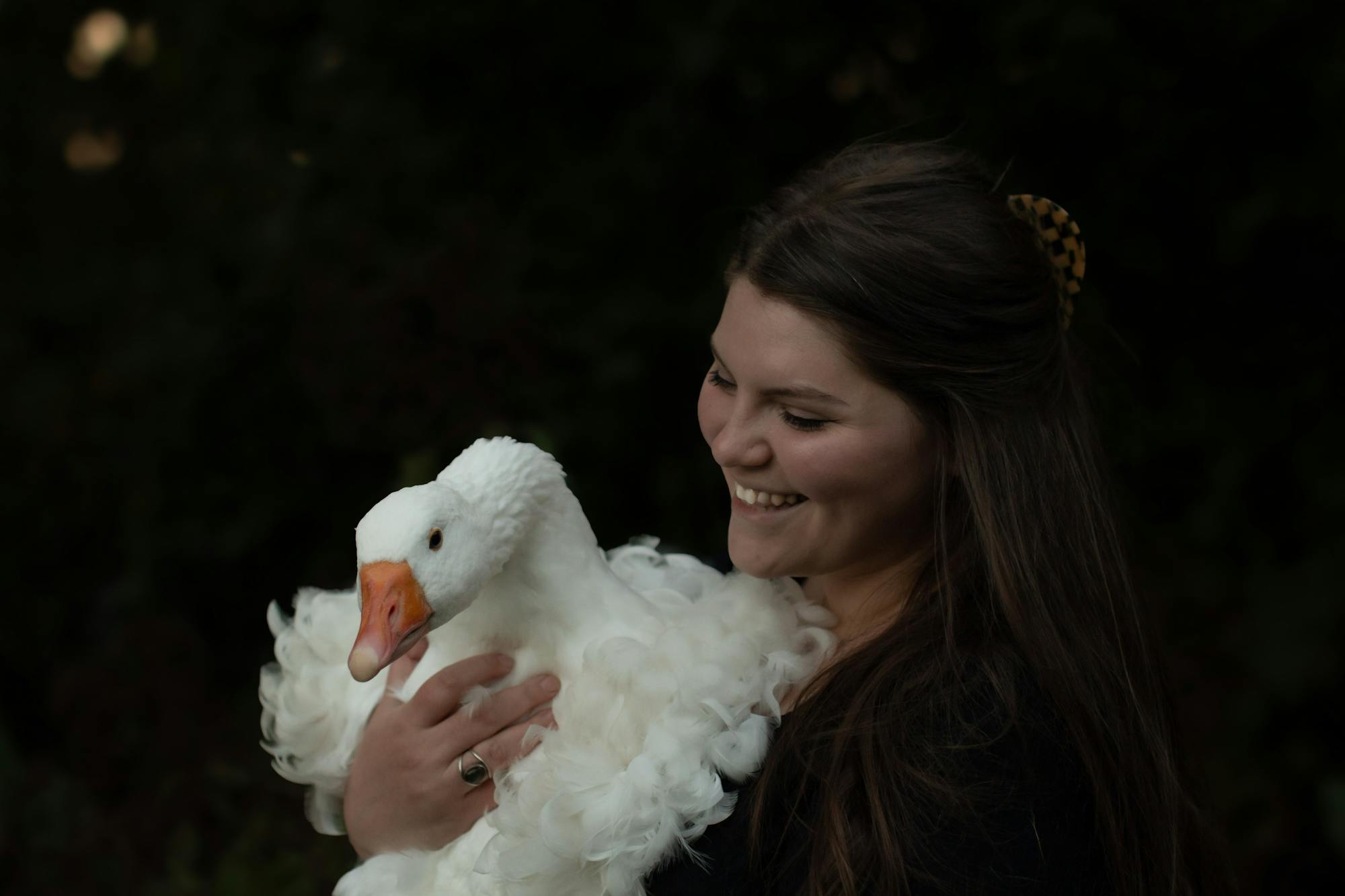 District staff member, Rebekkah, holding one of her beloved geese in her arms