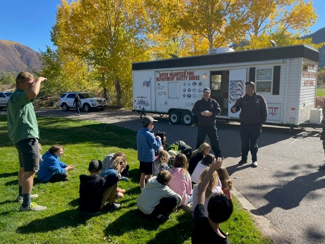 May contain: clothing, footwear, shoe, person, adult, male, man, car, transportation, vehicle, boy, child, hat, people, and truck