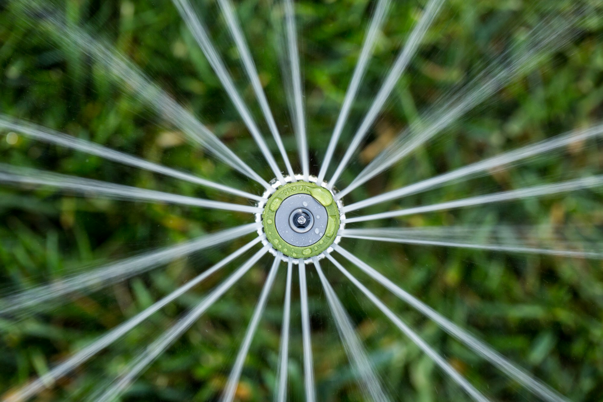 A high-efficiency sprinkler spraying water over grass.