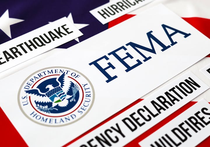 US flag background, FEMA signs, references to emergencies like earthquakes, hurricanes, and wildfires.