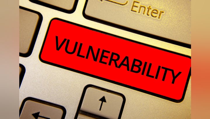 Close-up of a keyboard with a red "VULNERABILITY" label on a key.