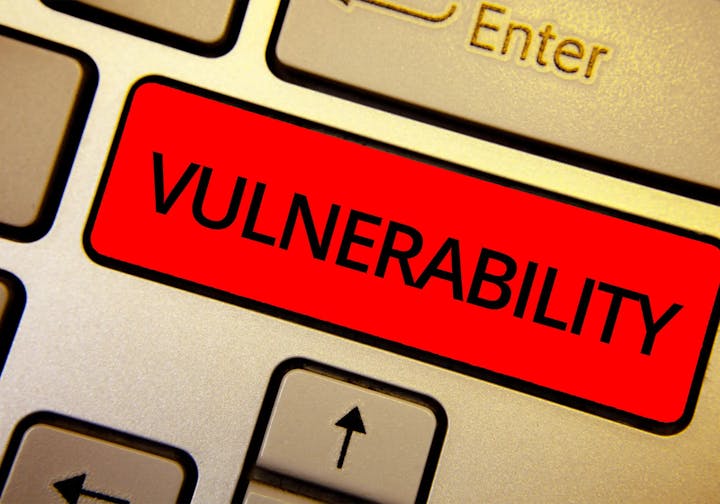 Close-up of a keyboard with a red "VULNERABILITY" label on a key.