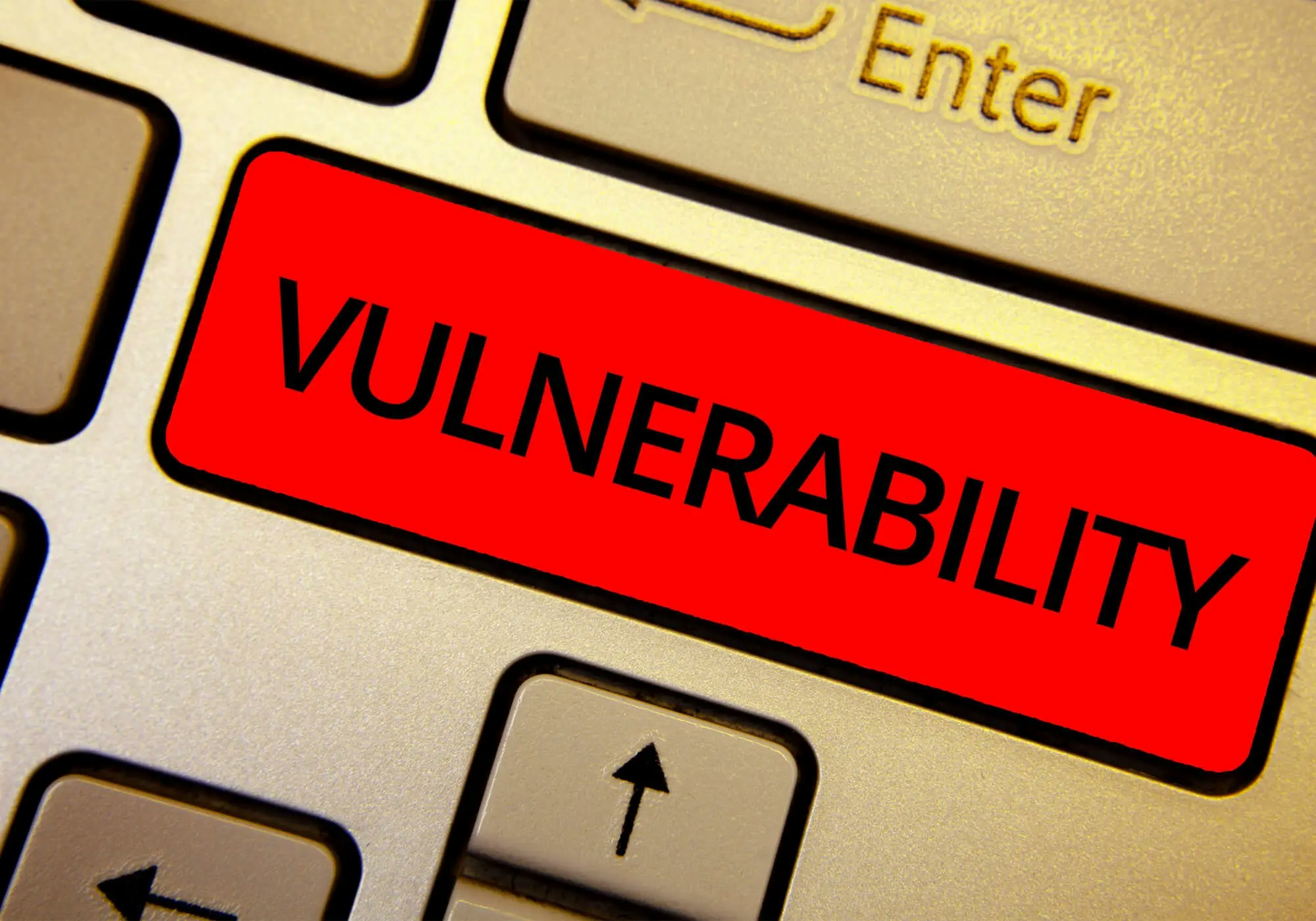 Close-up of a keyboard with a red "VULNERABILITY" label on a key.