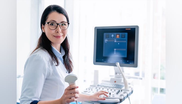 A medical professional with an ultrasound machine.