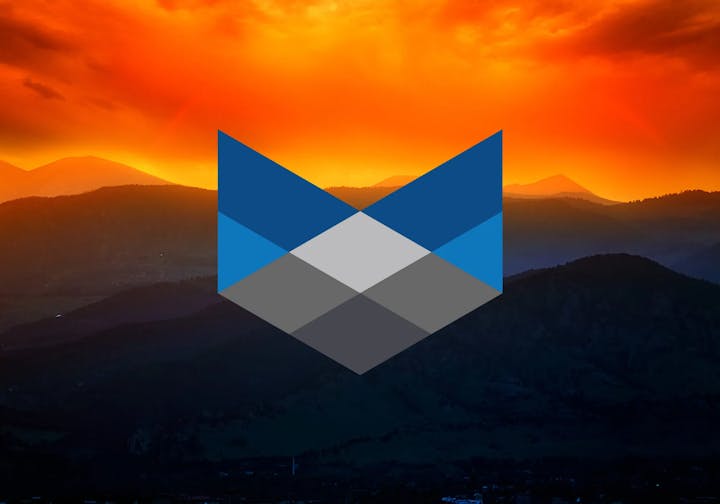 Fiery sunset over mountains with a blue-gray geometric overlay.