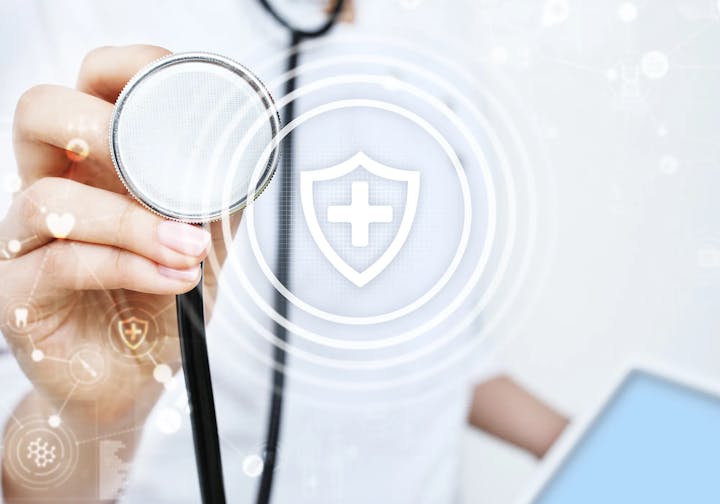 Doctor holding a stethoscope with healthcare icons and graphics overlay.