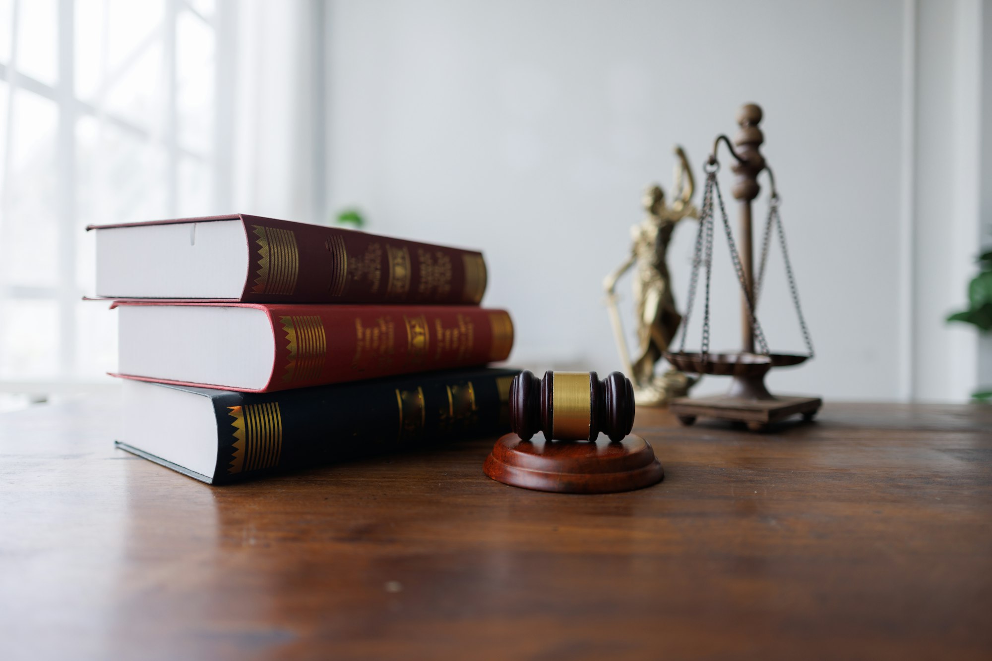 The image features legal books, a gavel, and a scale, symbolizing law and justice.