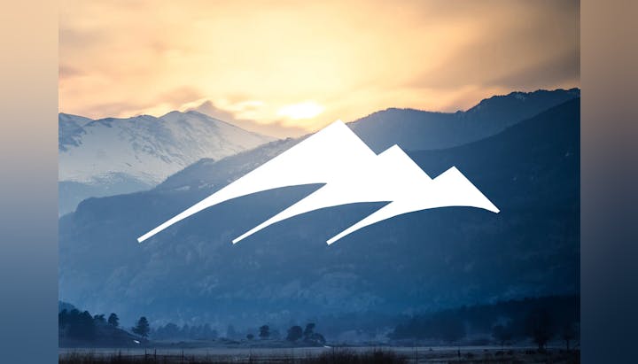 Sunset over snowy mountains with a graphic overlay.