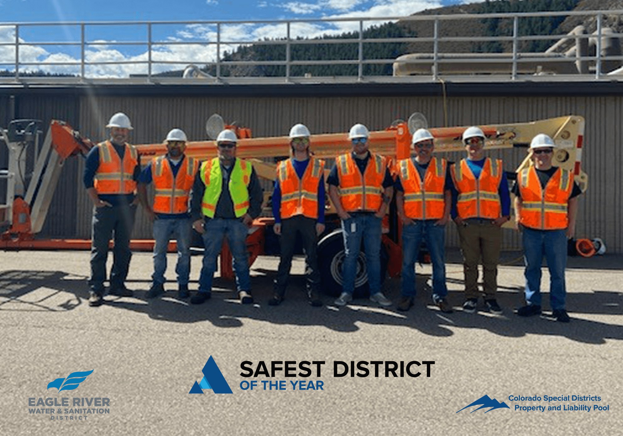 A group of workers in safety gear in front of industrial equipment with the text "Safest District of the Year."