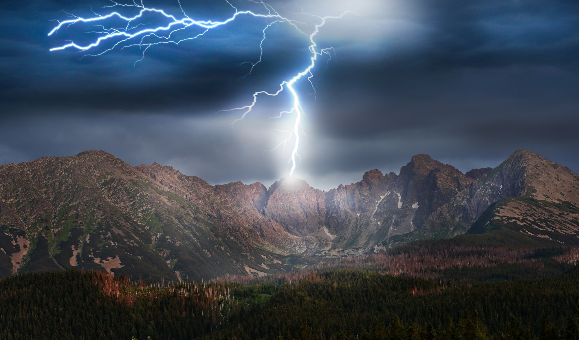 A dramatic landscape featuring mountains, a dense forest, and a significant lightning strike illuminating the scene.