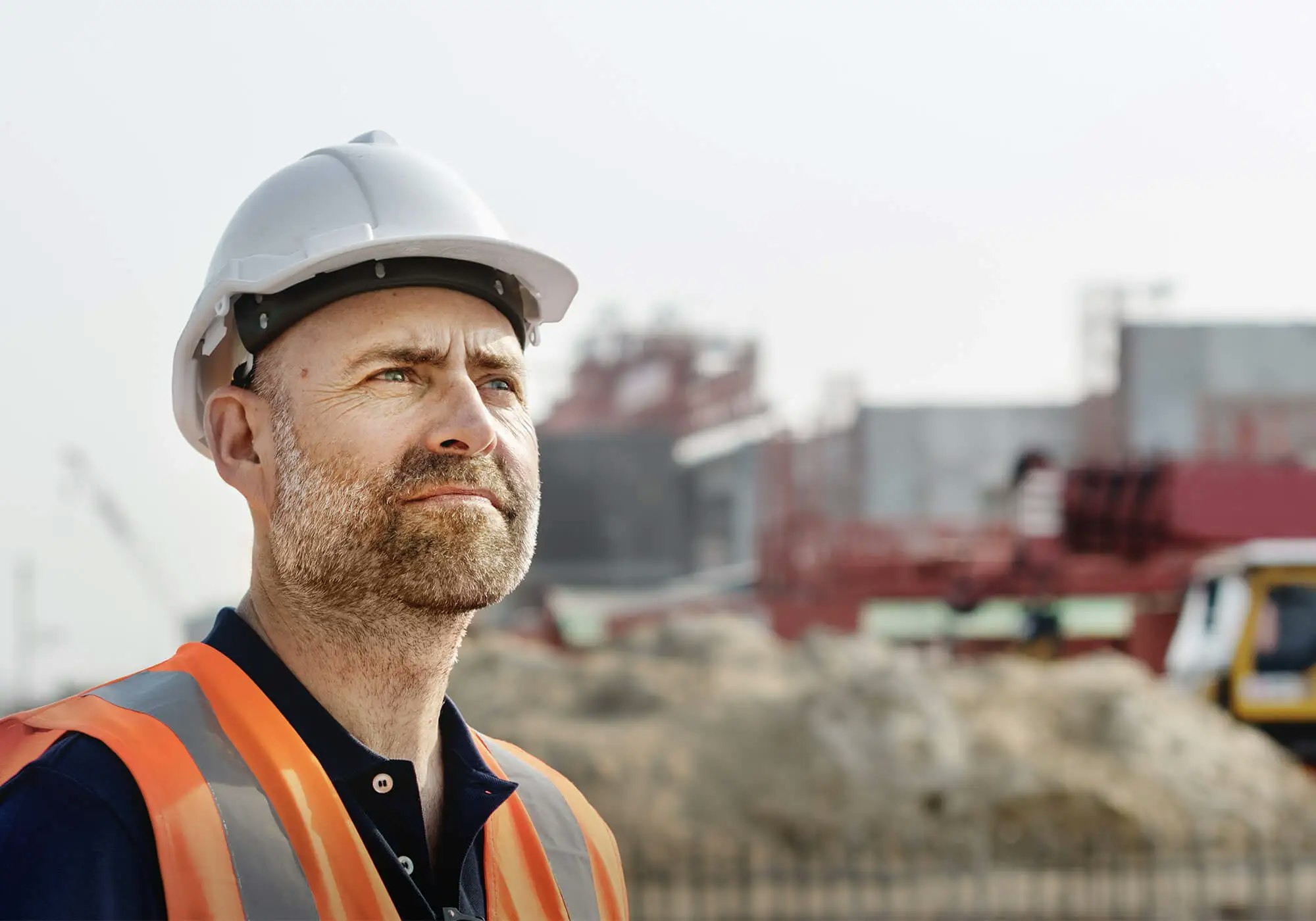 A man in a hard hat at a construction site.