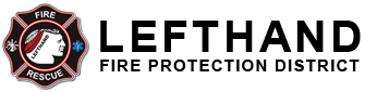 A fire and rescue service emblem with a firefighter profile and a Maltese cross.