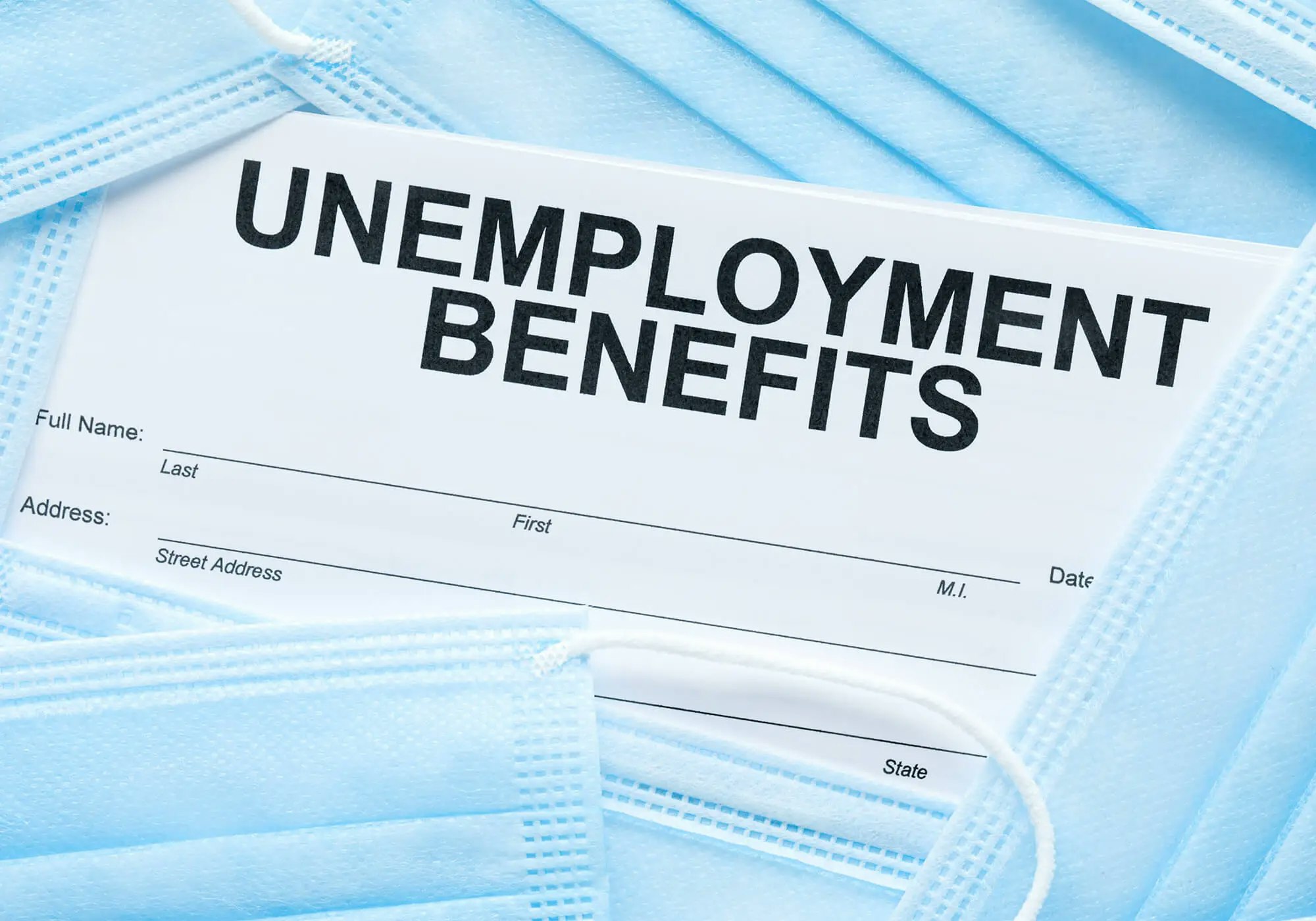 An unemployment benefits form on blue face masks.