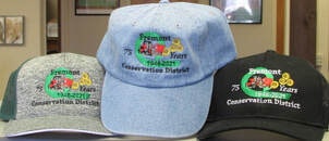 The image features three baseball caps with the logo of the Fremont Conservation District, celebrating 75 years.