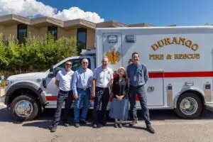Four individuals standing in front of a "Durango Fire & Rescue" ambulance.