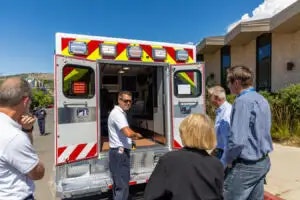People inspecting the inside of an ambulance.