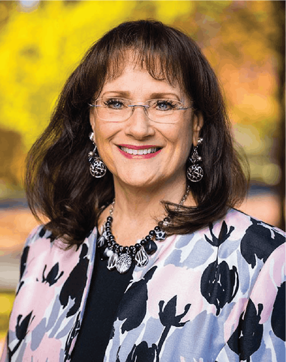 May contain: face, head, person, photography, portrait, happy, smile, blouse, clothing, accessories, jewelry, and necklace