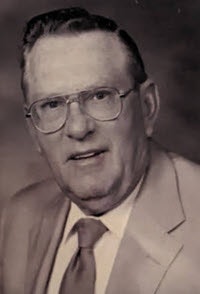 May contain: accessories, formal wear, tie, photography, face, head, person, portrait, glasses, adult, male, man, clothing, suit, and necktie