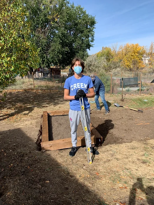 May contain: clothing, glove, adult, male, man, person, boy, teen, footwear, shoe, worker, device, shovel, tool, bench, and furniture