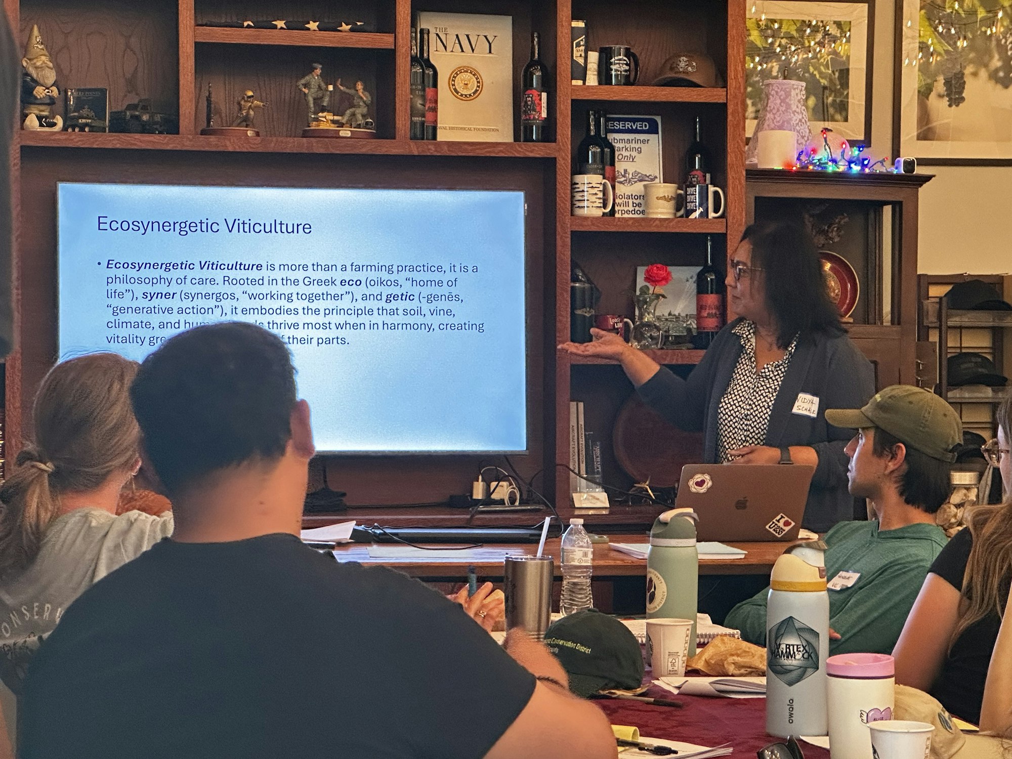 A presentation on "Ecosynergetic Viticulture," discussing the harmony of soil, vine, climate, and human care in farming.