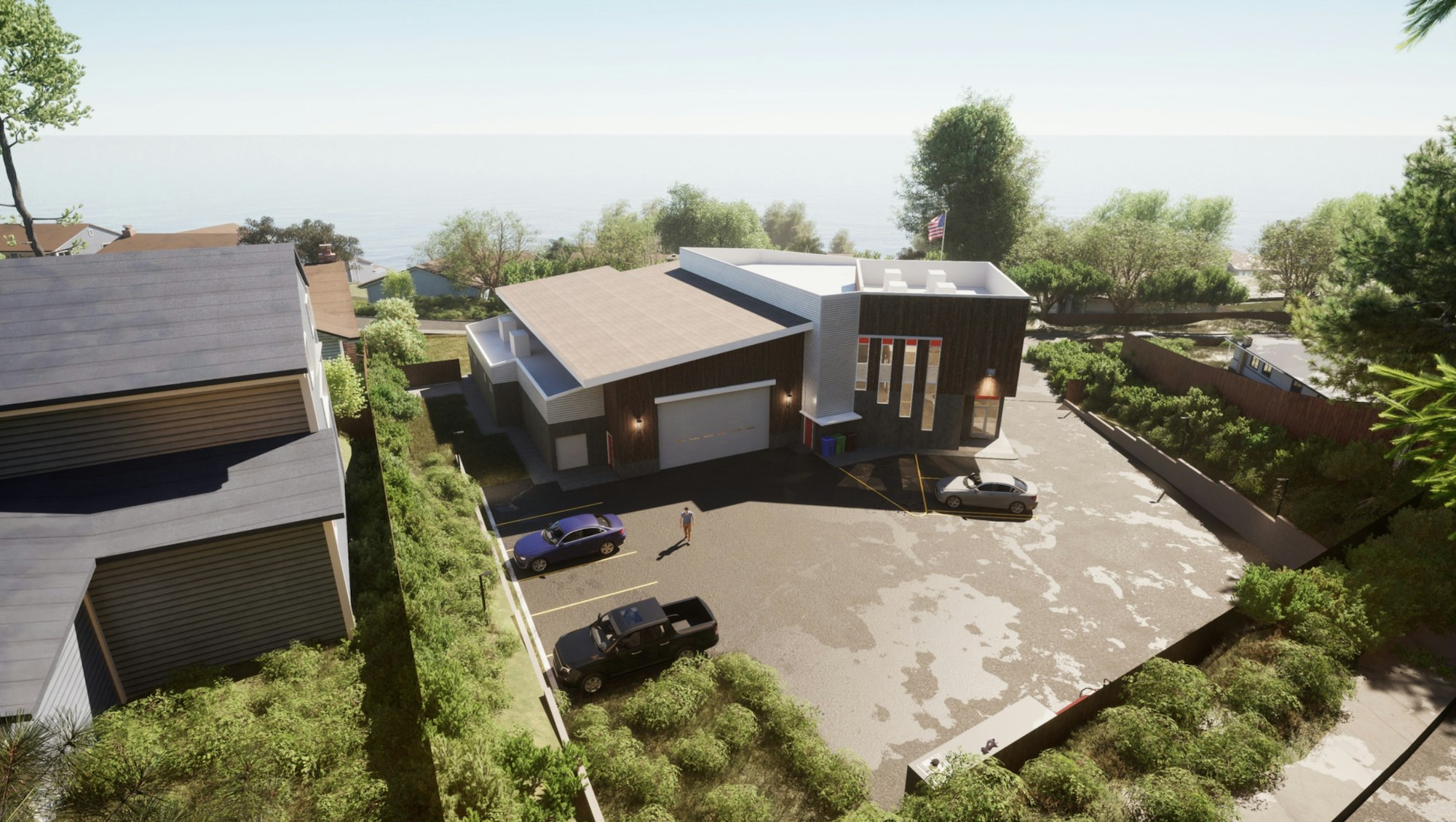 Modern house with driveway, cars, and sea view.