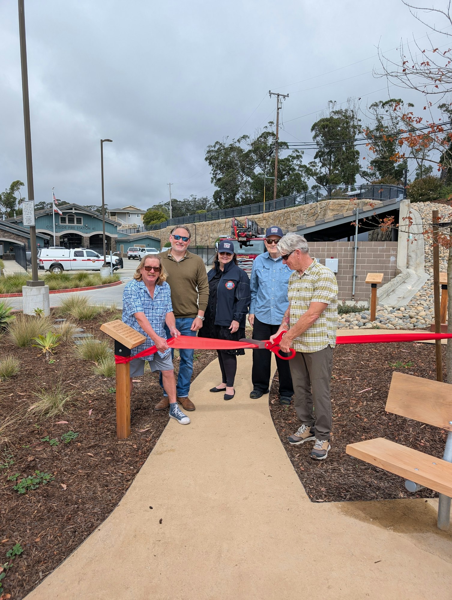 Board of Directors cut the ribbon at the newly landscaped lot at Station 41