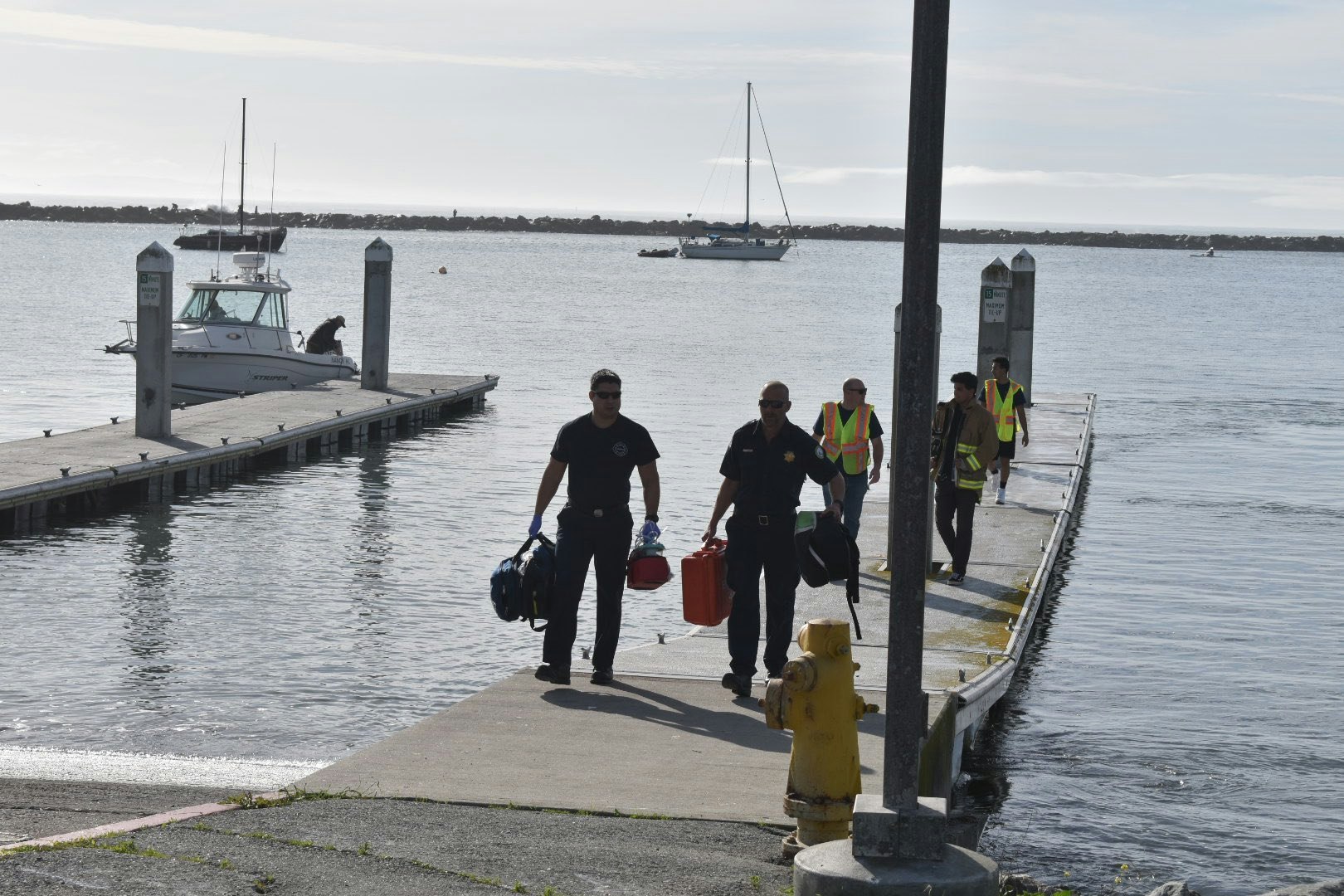 May contain: water, waterfront, person, human, pier, port, dock, boat, vehicle, transportation, fire hydrant, hydrant, watercraft, and vessel