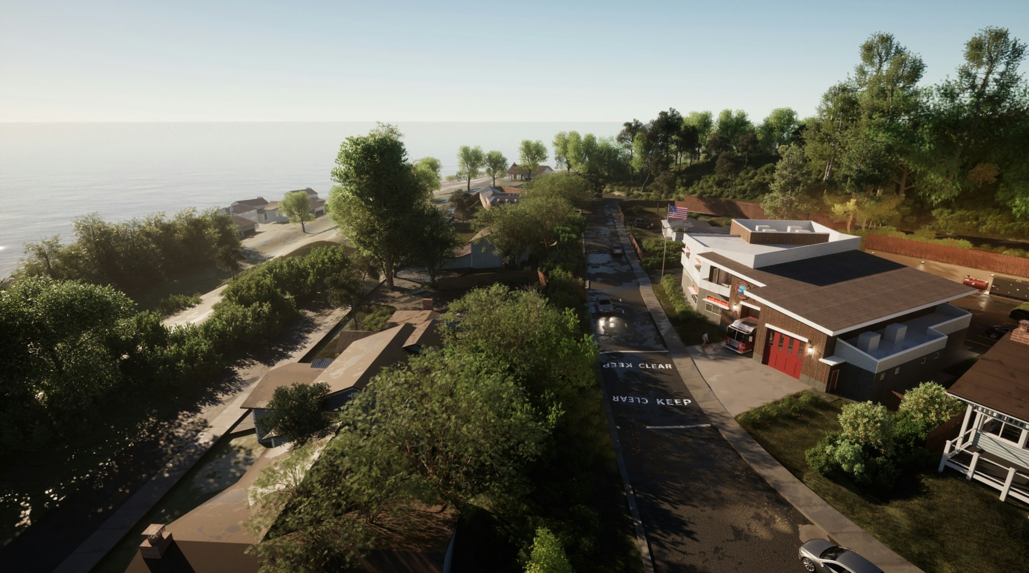 A coastal residential area with houses, lush trees, a fire station, cars, and clear skies.