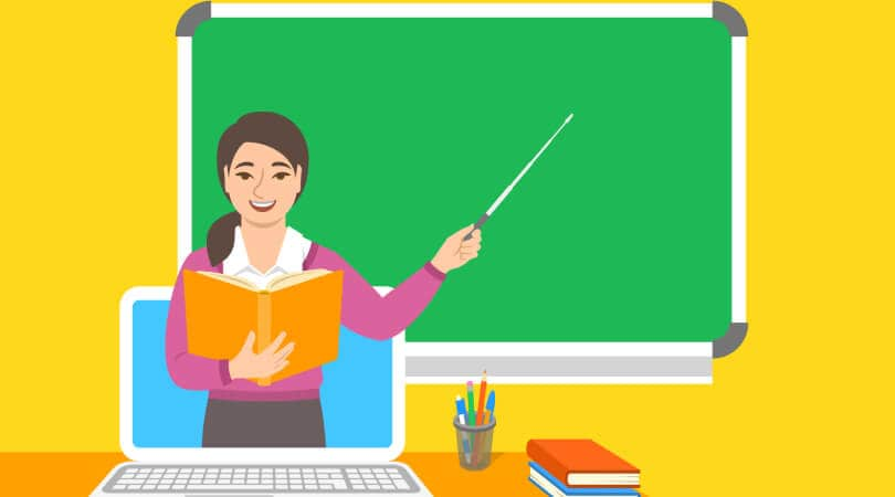 An animated teacher holding a book and pointer in front of a chalkboard, with a computer and books on the table.