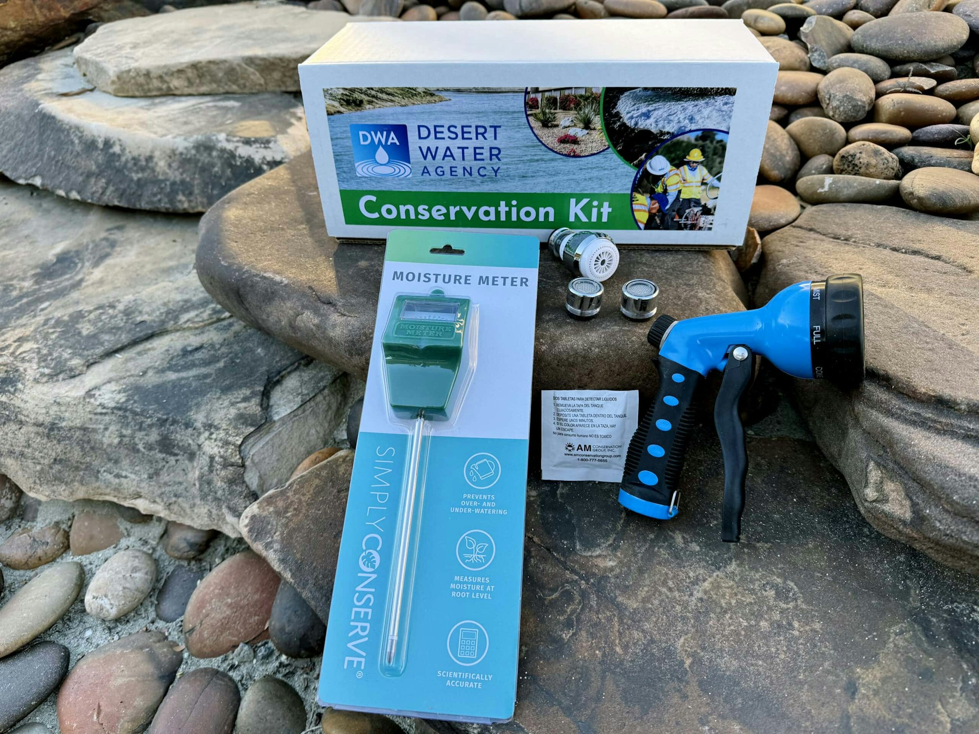 A conservation kit from Desert Water Agency, featuring a moisture meter, a spray nozzle, and components for water-saving.