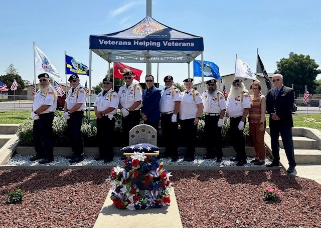 May contain: clothing, glove, flag, people, person, hat, footwear, shoe, and officer