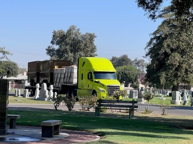 May contain: truck, transportation, vehicle, grass, and plant