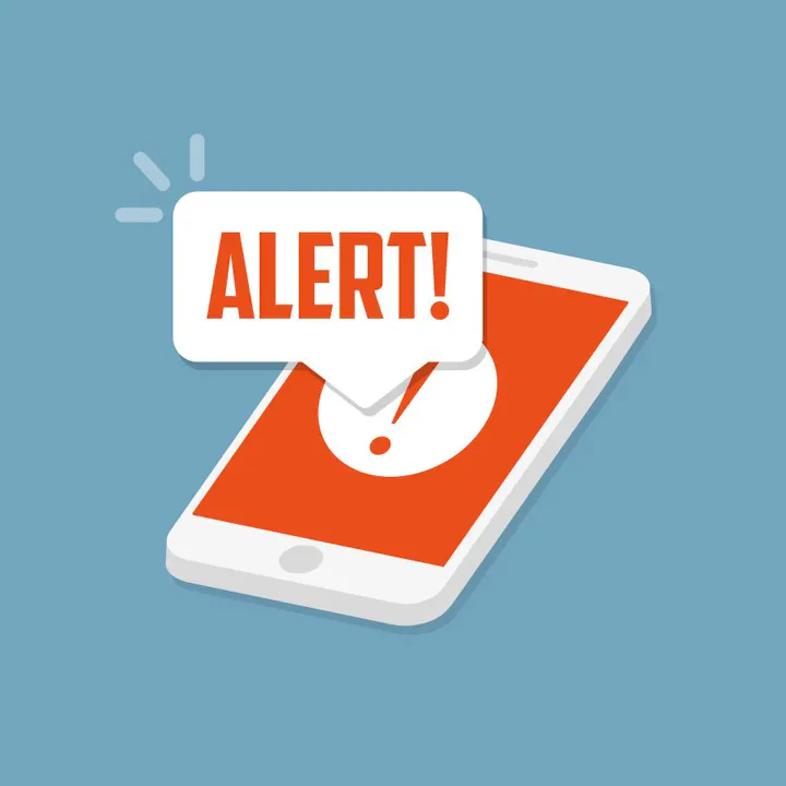 A smartphone with a red alert notification popup saying "ALERT!" on a blue background.