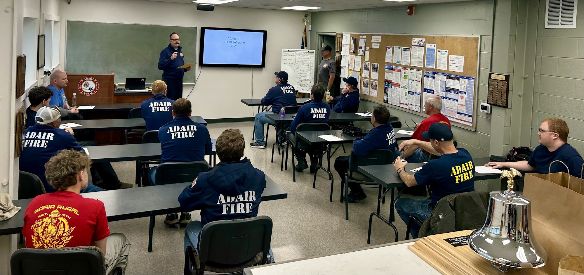 A group of people in a classroom setting attending a fire training refresher course, focused on learning and discussion.