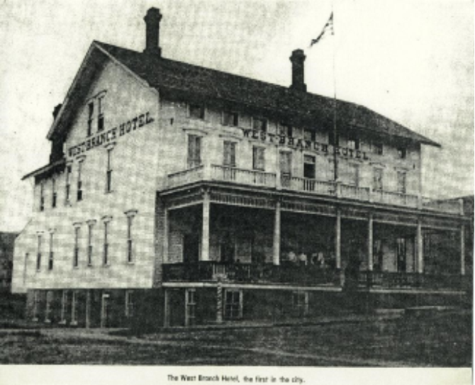 Historic photo of the West Branch Hotel, two-story building with porch and chimneys, first in the city.