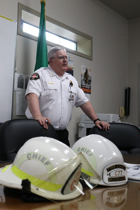 May contain: helmet, adult, male, man, person, accessories, glasses, chair, furniture, captain, officer, bracelet, jewelry, flag, and police officer