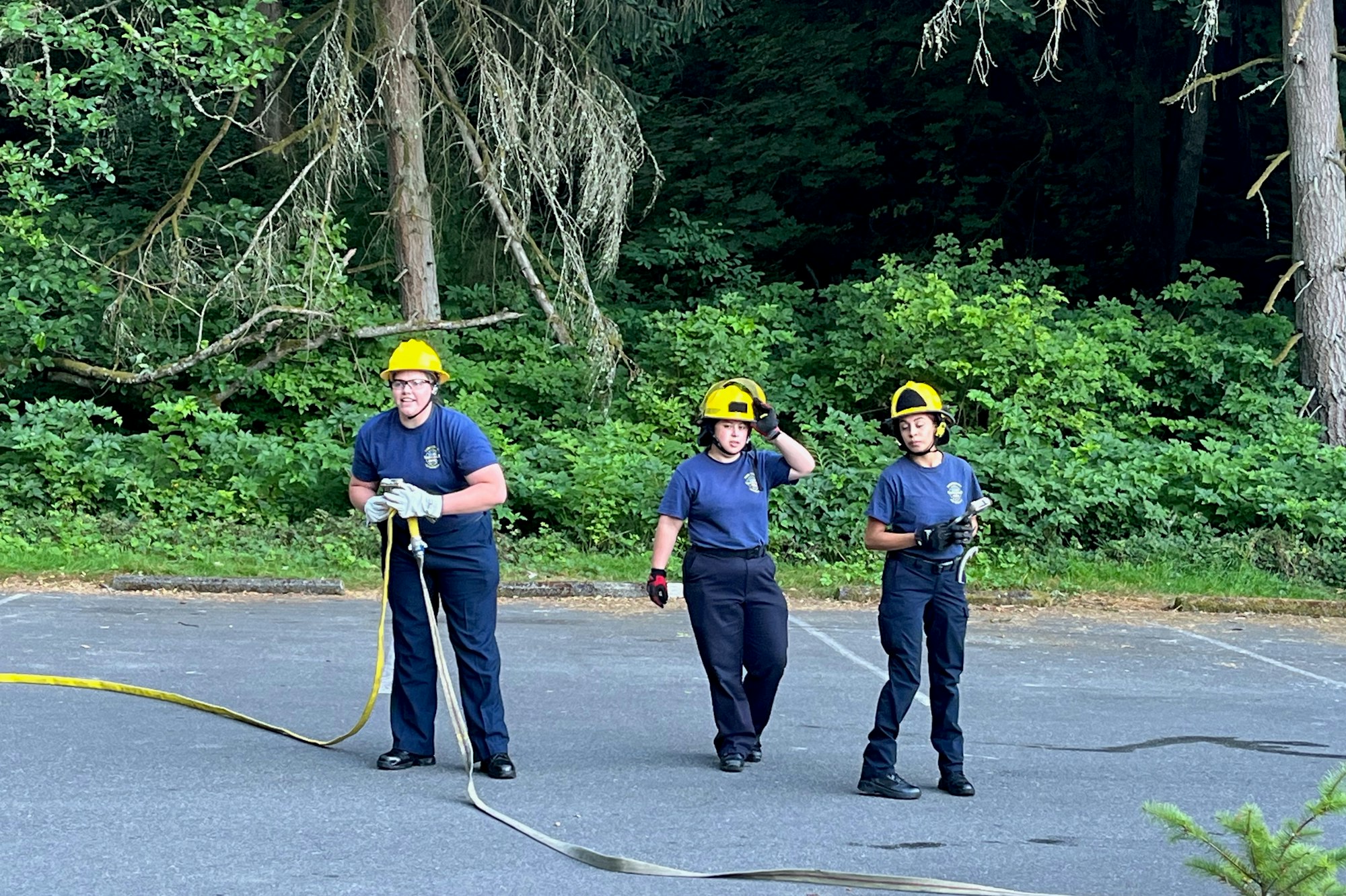 3 women firefighters deploying wildland hose