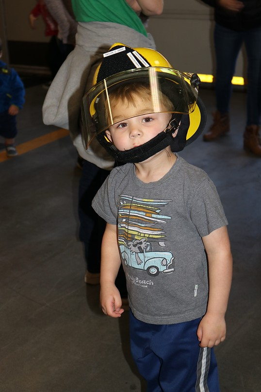 May contain: helmet, clothing, hardhat, crash helmet, t-shirt, face, head, person, photography, portrait, boy, child, male, footwear, and shoe