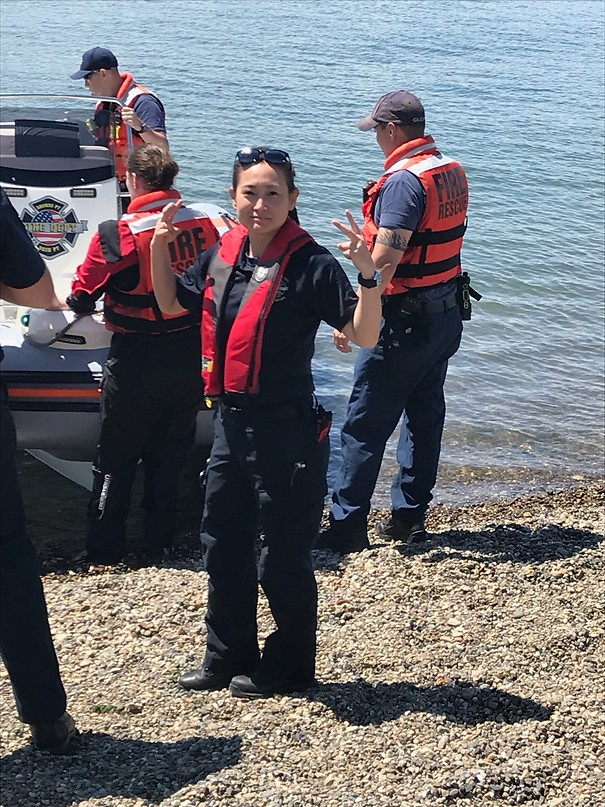 May contain: clothing, vest, lifejacket, glove, footwear, shoe, person, wristwatch, hat, accessories, glasses, face, head, photography, and portrait