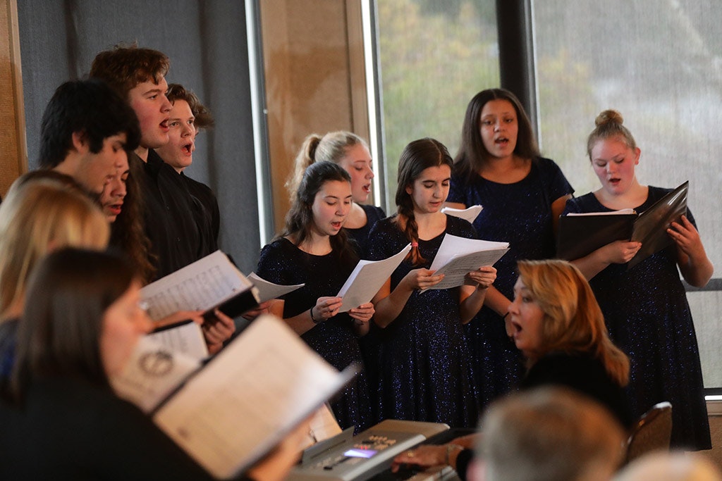 May contain: person, human, audience, crowd, and sitting