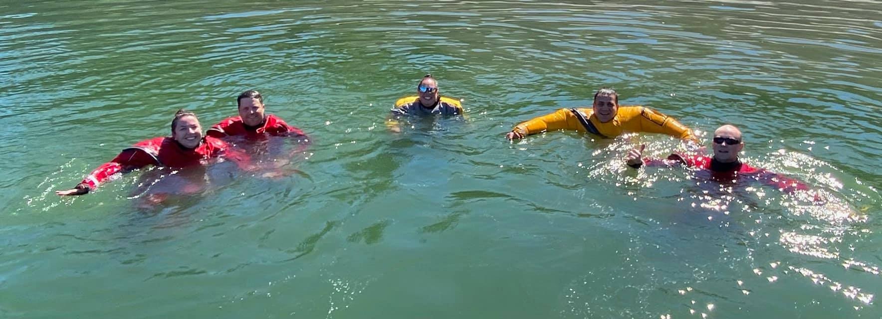 May contain: clothing, apparel, swimming, water, person, sport, human, sports, lifejacket, and vest